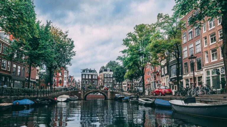 A picturesque Amsterdam canal lined with trees and historic buildings