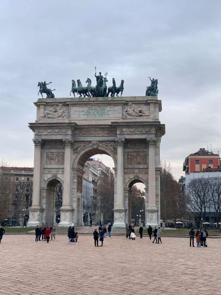 Arco della Pace in Milan with people walking in the foreground