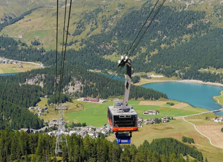 Cable car ascending in St. Moritz with scenic mountain views