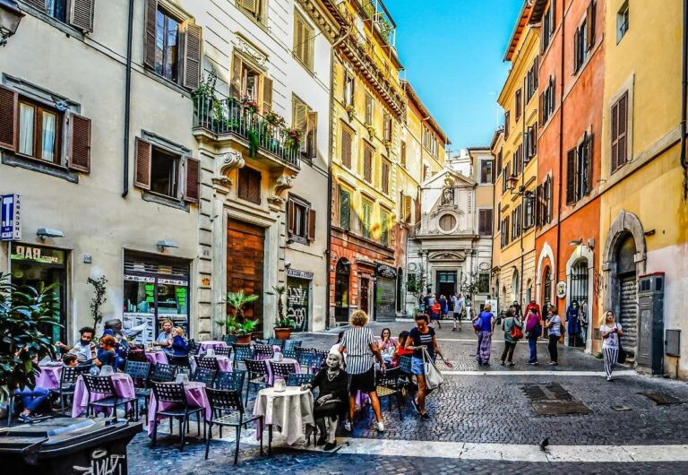 Bustling street in Rome with outdoor cafes and people walking