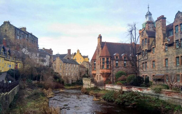 Picturesque view of colorful buildings along a river in Edinburgh