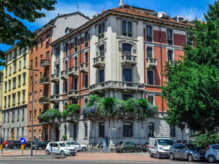 Historic building in Milan with ornate balconies and vibrant colors