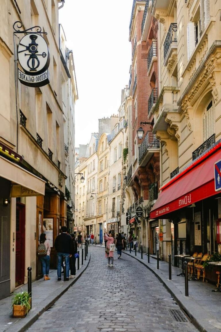 Charming cobblestone street in Paris with cafes and pedestrians