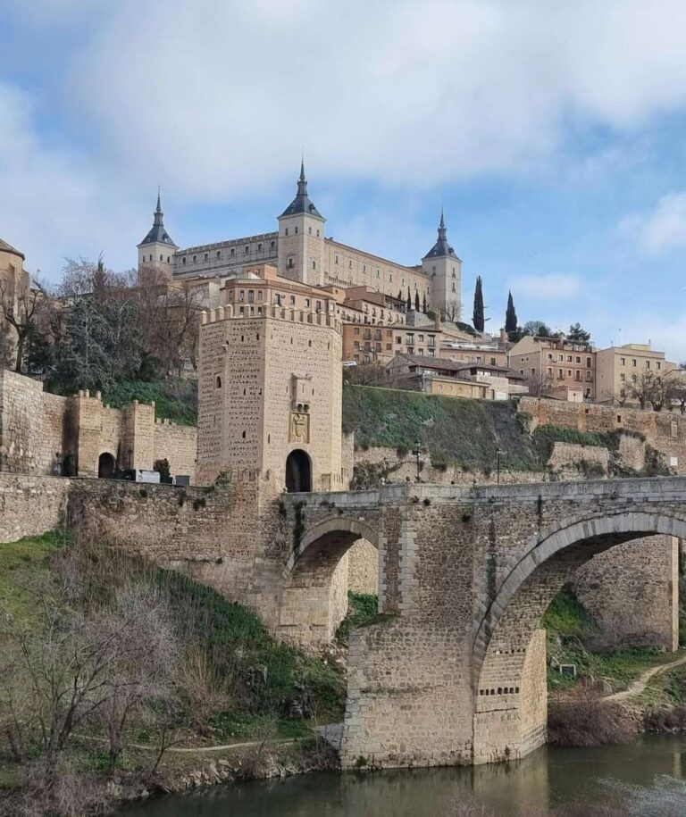 Alcázar (castle) of Toledo with stone bridge over a river