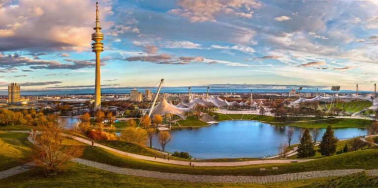 Panoramic view of Munich's Olympic Park with tower and lake