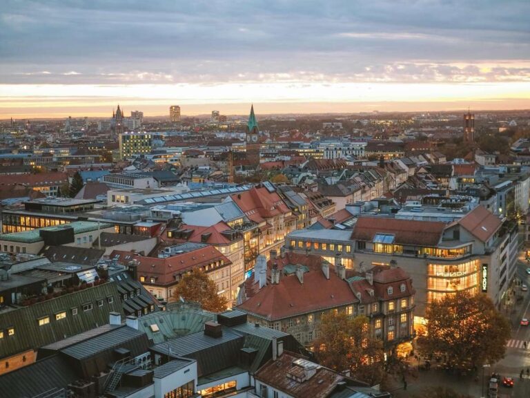 Sunset view of Munich cityscape with red-roofed buildings