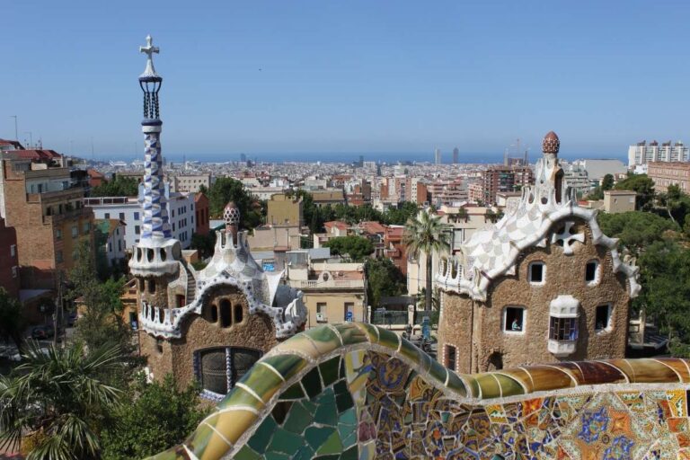 Colorful mosaic architecture in Park Güell with a cityscape view in Barcelona