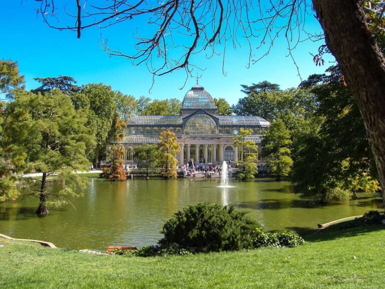 Scenic view of the Glass Palace by a lake in Retiro Park, Madrid