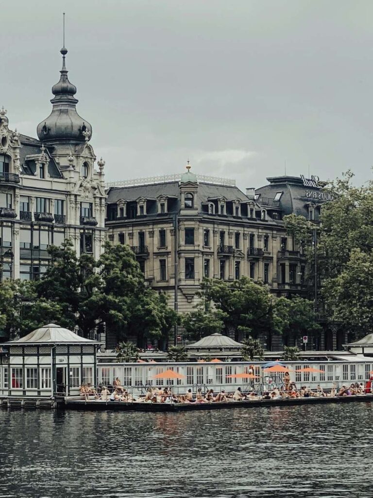 Historic buildings and river bath area in Zurich on a cloudy day