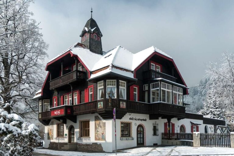 A traditional alpine house in Innsbruck covered in snow