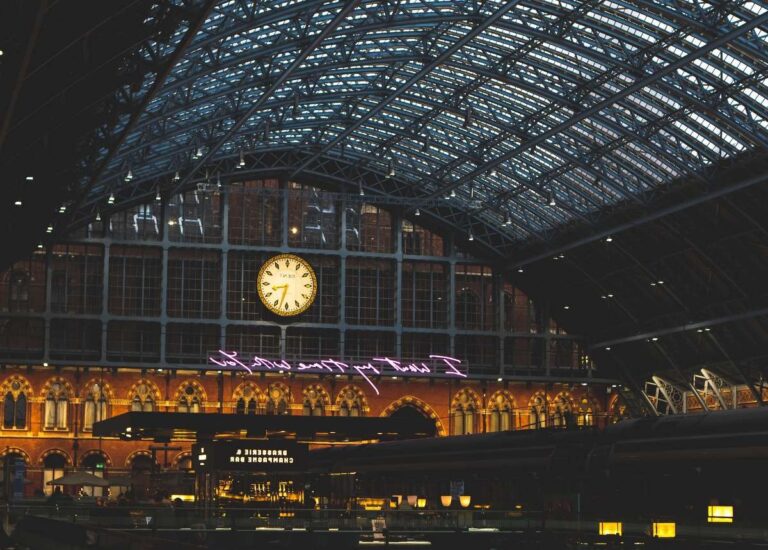 Interior view of a grand train station in St. Moritz with clock