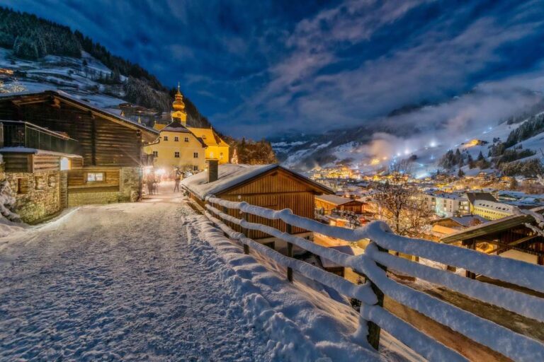 A snowy village scene in Salzburg under a starry night sky