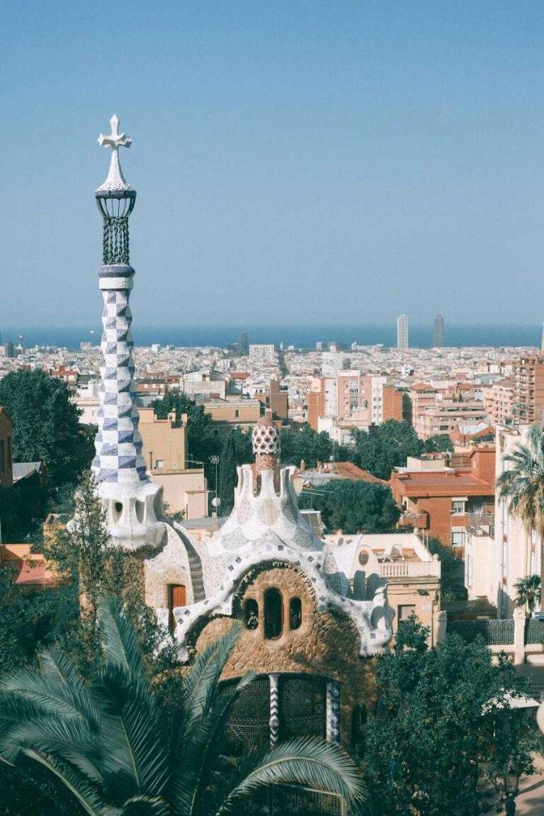 Colorful mosaic structures with cityscape and sea view from Park Güell, Barcelona