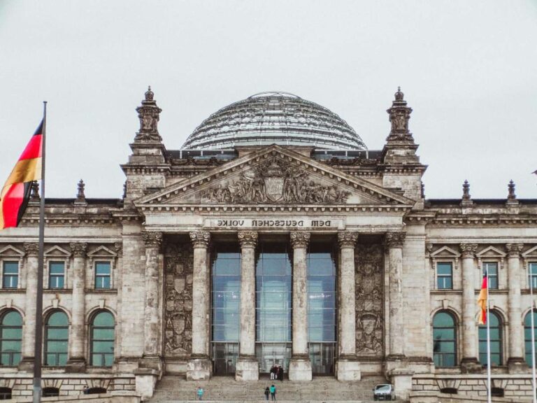 Bundestag in Berlin with German flags and glass dome