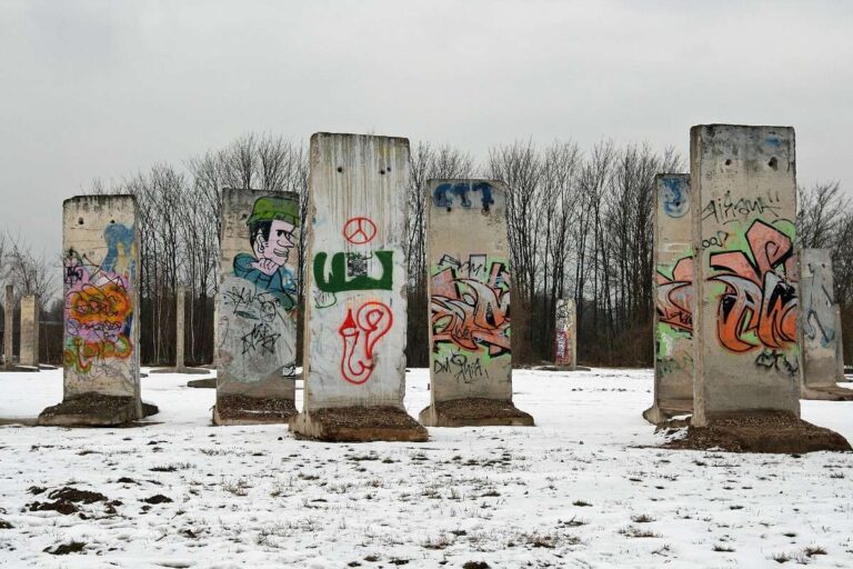 Graffiti-covered Berlin Wall remnants in a snowy field