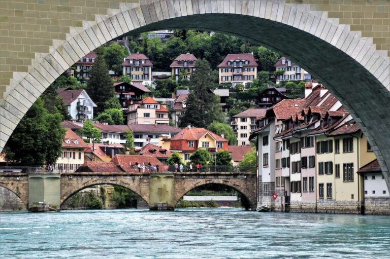 View of Bern's old town through a stone arch bridge over a river