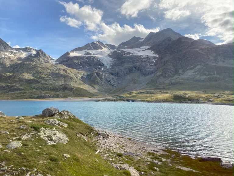 Mountain lake with rocky shores under cloudy skies