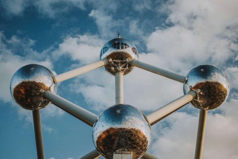 Close-up view of the Atomium's reflective spheres against a blue cloudy sky