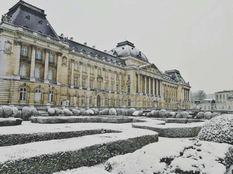 Snow-covered garden with a historic building in Brussels