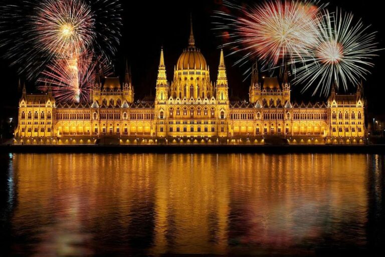 Hungarian Parliament building with fireworks reflecting on the river