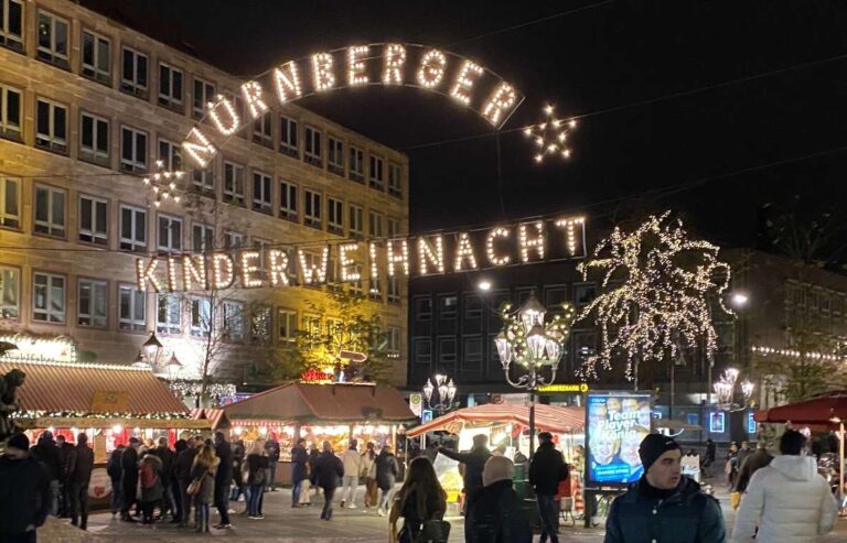 Illuminated 'Nürnberger Kinderweihnacht' sign at a Christmas market in Nuremberg