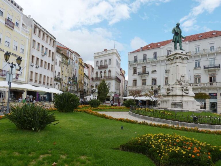 Central square in Coimbra with a statue and historical buildings