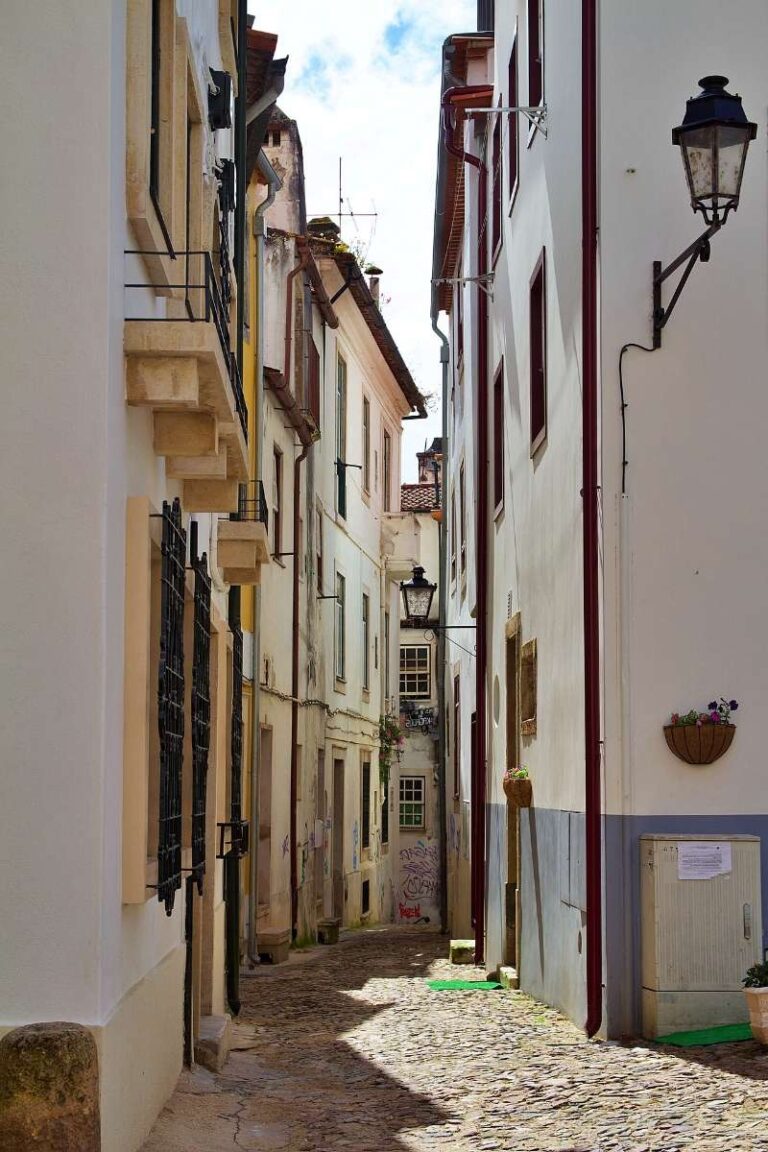 Narrow, picturesque alley in Coimbra's old town with traditional buildings