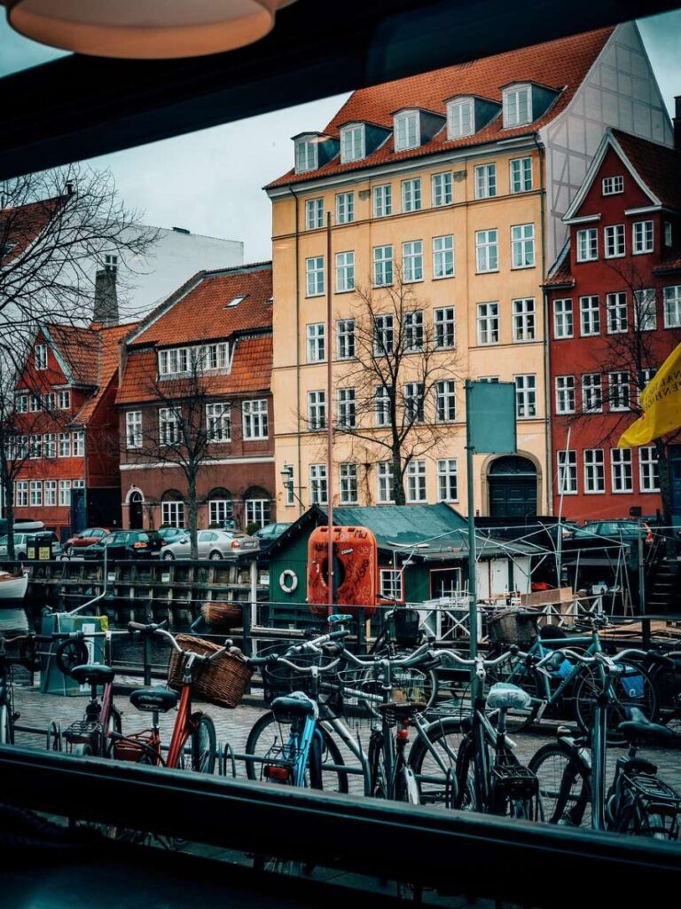 Bicycles lined up along a colorful canal in Copenhagen