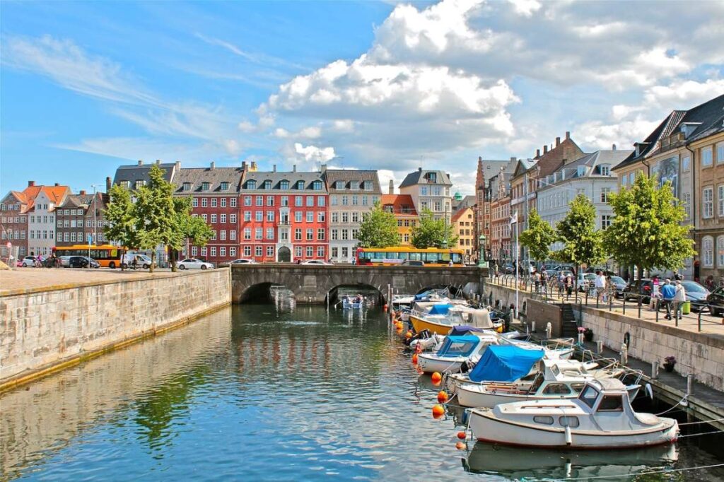 Boats docked along a vibrant canal in Copenhagen