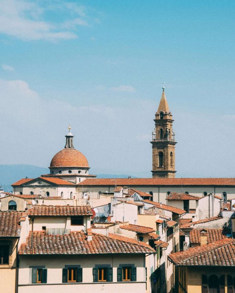 View of Florence skyline featuring rooftops, a dome, and a bell tower