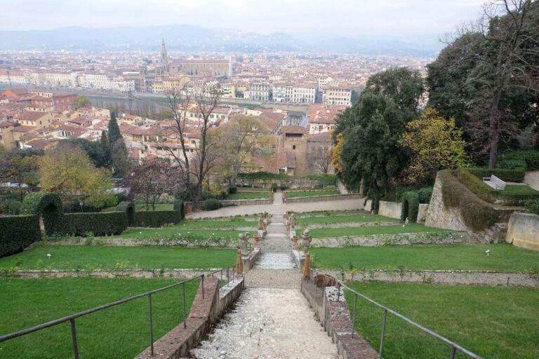 Stone steps leading down through a lush garden overlooking Florence