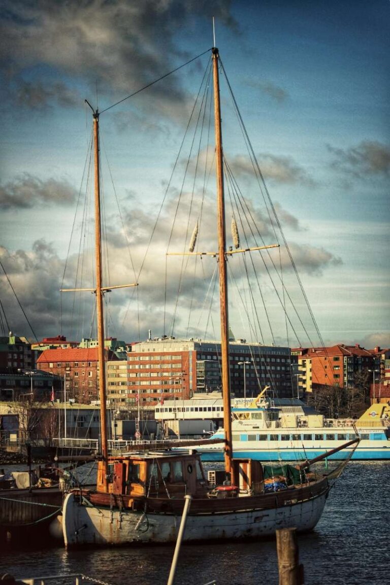 A sailing boat docked in Gothenburg's harbor under a cloudy sky