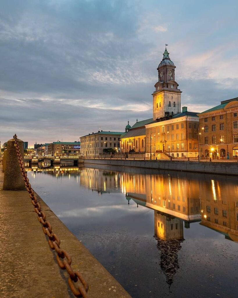 A picturesque riverwalk with a church in Gothenburg