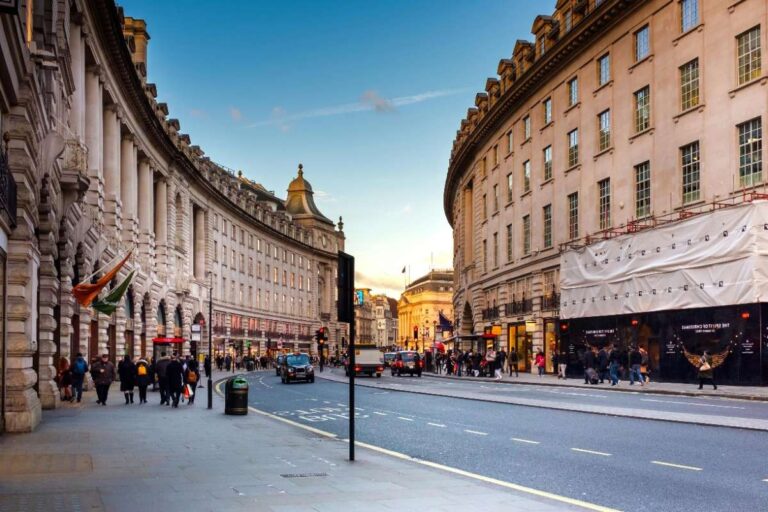 View of bustling street in London City Centre with curved architecture