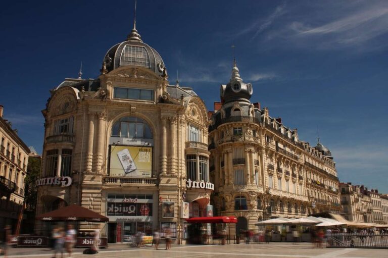 Historic building with intricate architecture on a busy city square