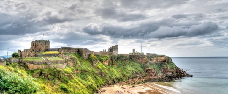 Ancient castle perched on cliffs overlooking the beach in Newcastle