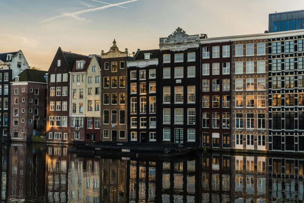 Row of traditional Dutch houses reflecting on the canal water