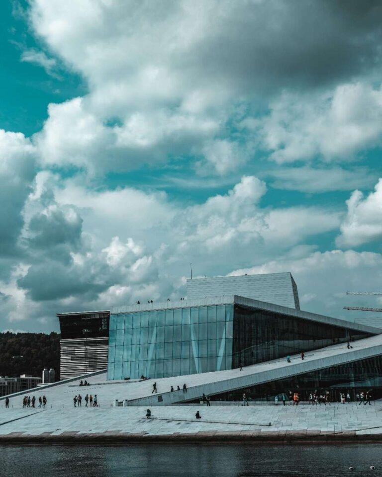 The modern architecture of Oslo's Opera House against a cloudy sky