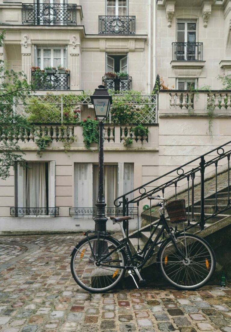 A vintage bicycle parked on a cobblestone street in Paris