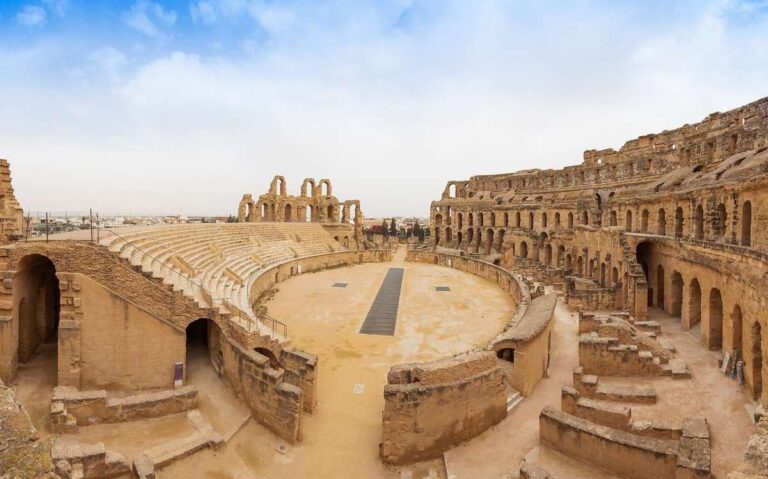 Interior of the Colosseum in Rome, displaying ancient stone seating and arches