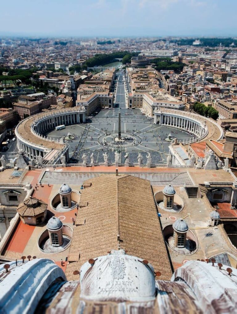 Aerial view of St. Peter's Square in Vatican City, surrounded by Rome's skyline