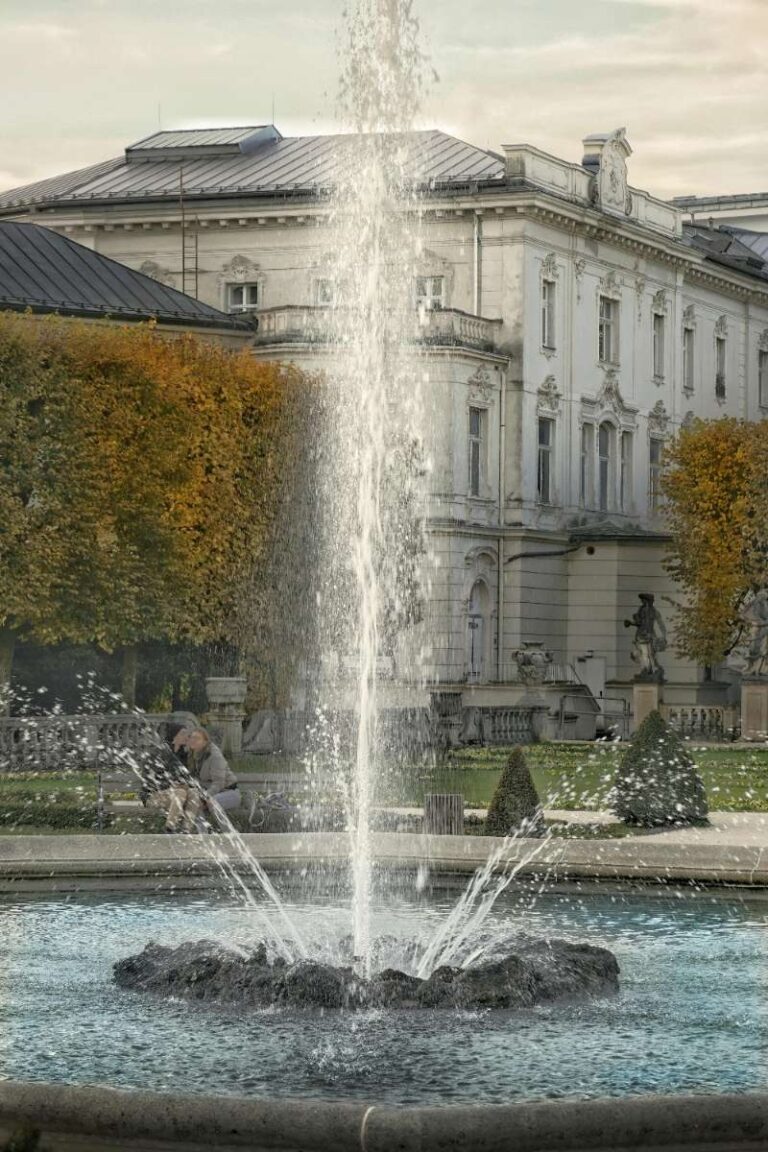 a water fountain inside of a garden of a palace in Salzburg