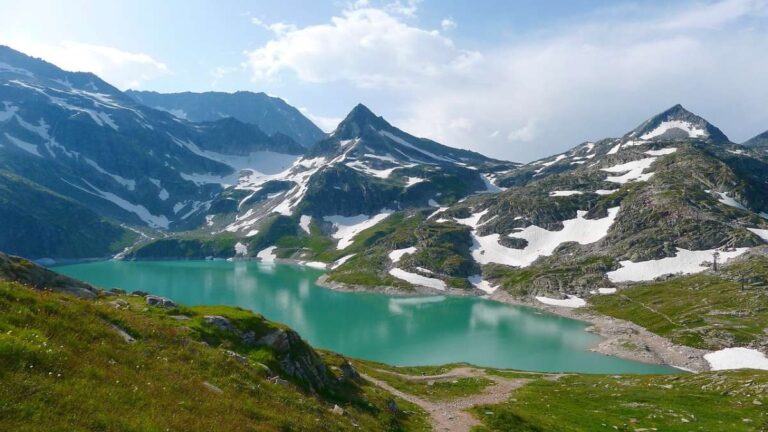 a lake surrounded by mountains with remaining snow in close to Salzburg