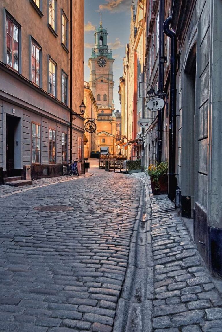 Pictures church of stockholm in the end of a narrow street in the historical old town