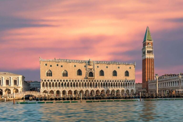 Venice's St. Mark's Square at sunset with the iconic bell tower and buildings