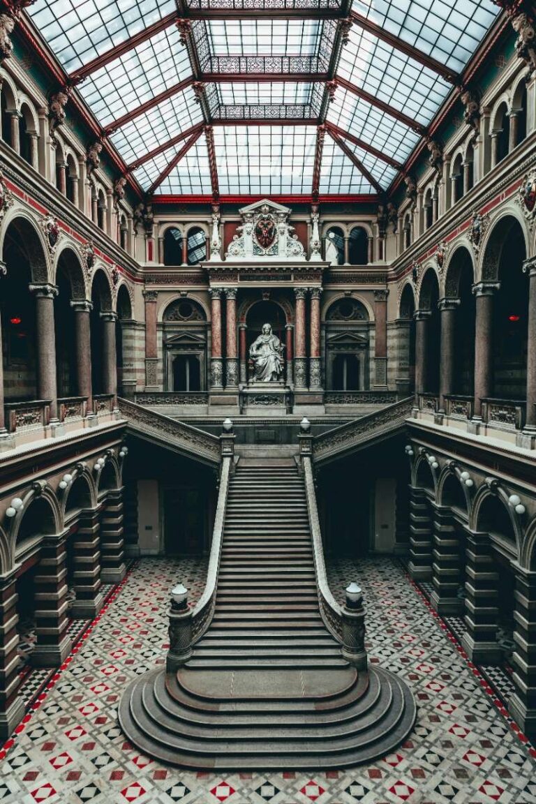 a staircase in a symmetric building with a giant dome in Vienna