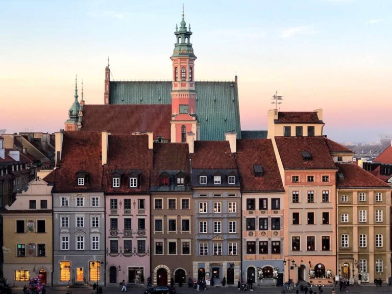 Colorful historic buildings in Warsaw's Old Town at sunset