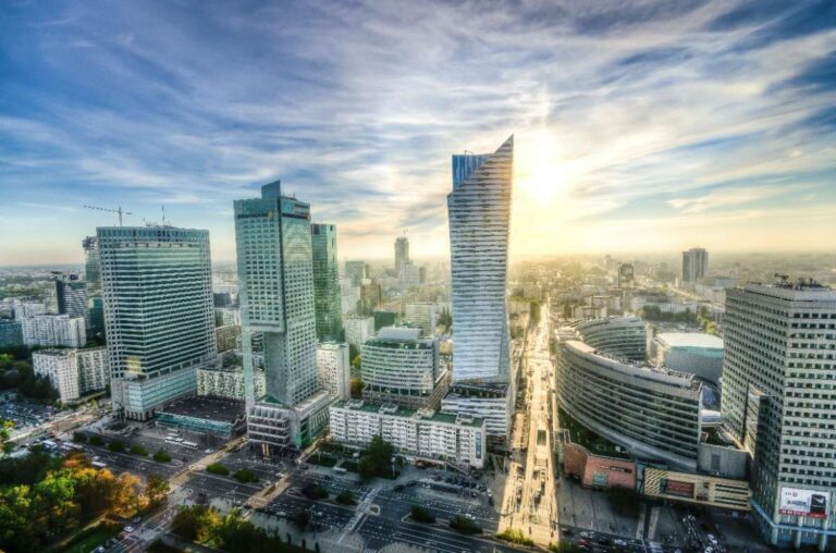 Panoramic view of Warsaw's modern skyline at sunrise with skyscrapers and cityscape