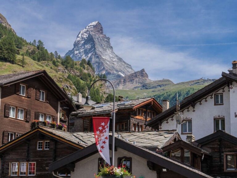 View of the Matterhorn behind traditional Swiss chalets in Zermatt