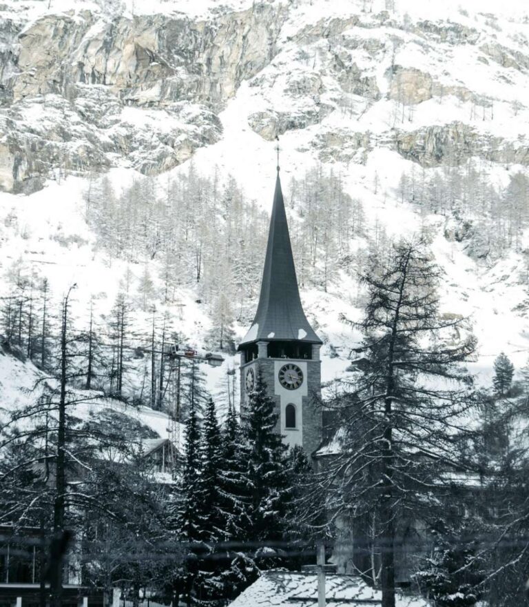 St. Mauritius Church in Zermatt surrounded by snow-covered trees